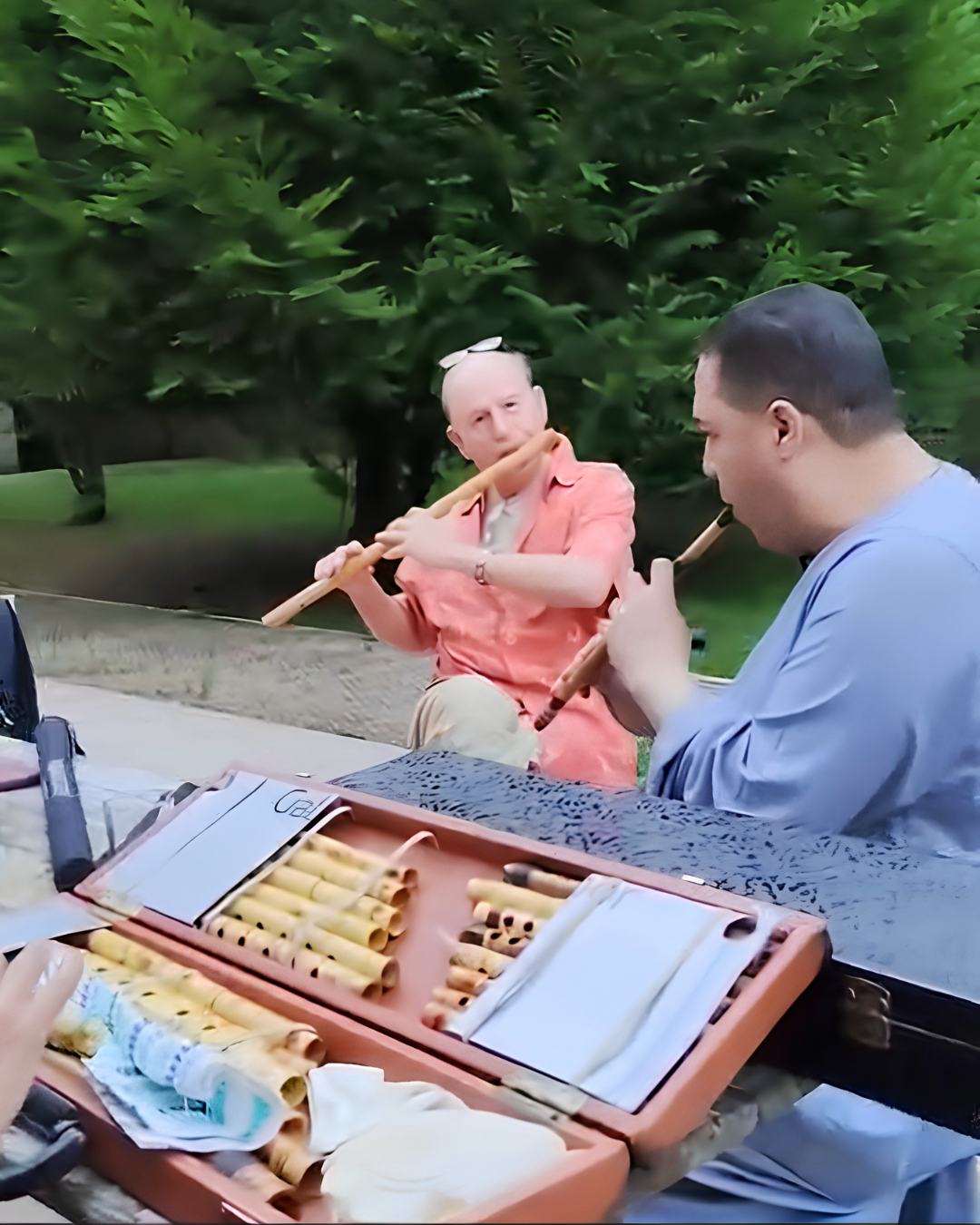 Two musicians performing outdoors