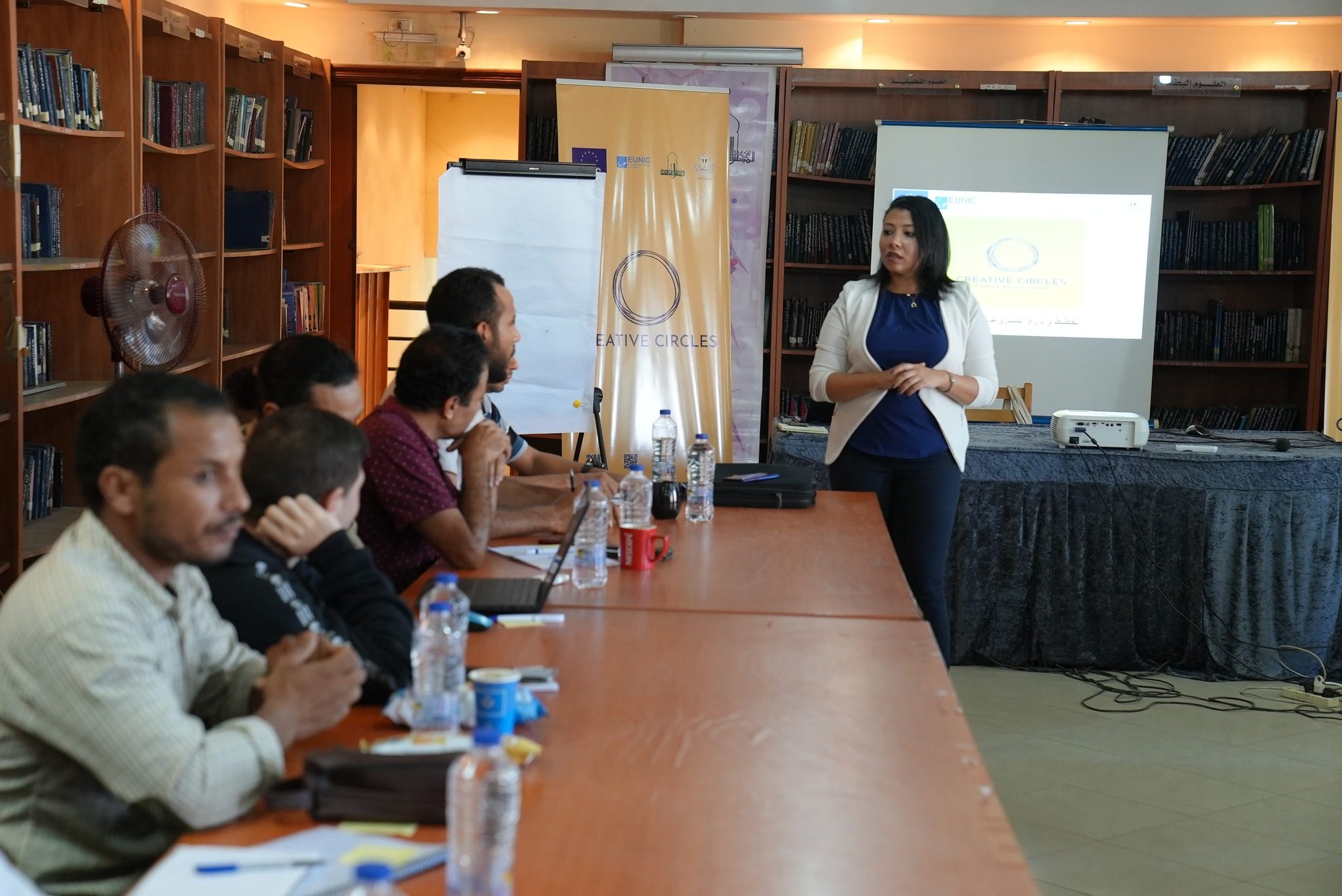A seminar taking place in a library reading room