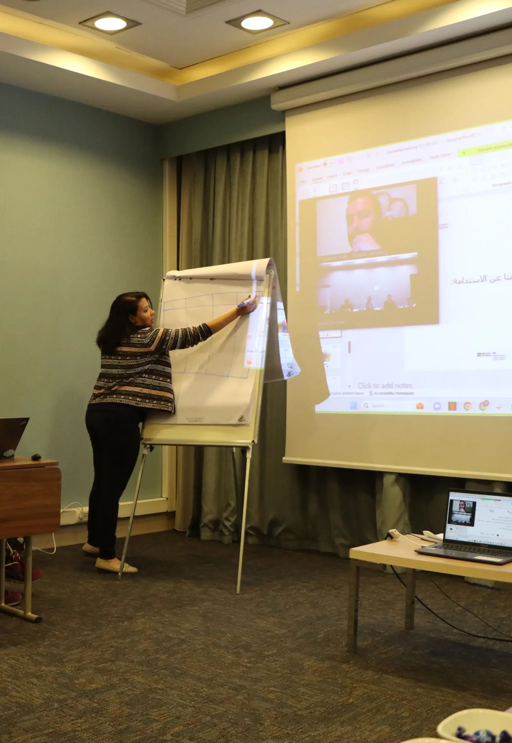 A facilitator writing on a flipchart during a training session
